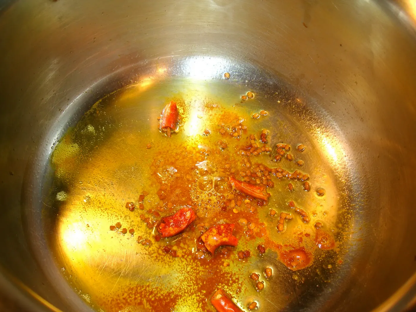 Frying the whole spices until fully fragrant before adding pumpkin shoots.