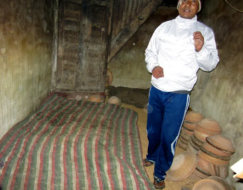 Mr. Pradhananga is leaving the room with covered yogurt containers. He will be back when the yogurt is ready. He will move the yogurt container to the shelves during which time, it will thicken further.