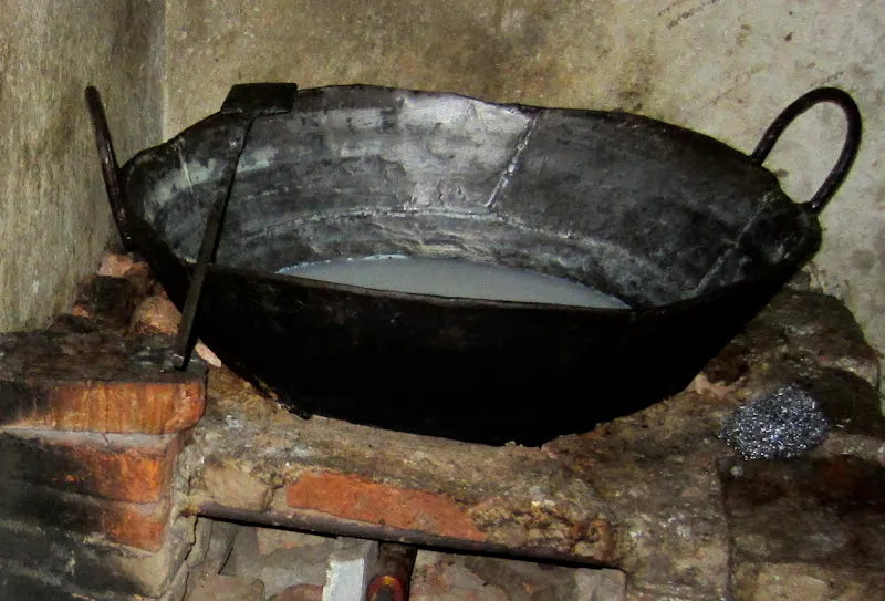 Heating buffalo milk (bhaisi ko doodh) in a heavy bottomed pot (karaahi) over direct heat. Stirring constantly to prevent sticking until milk has thickened. It may take about 1 1/2 hours depending upon the amount of the milk.