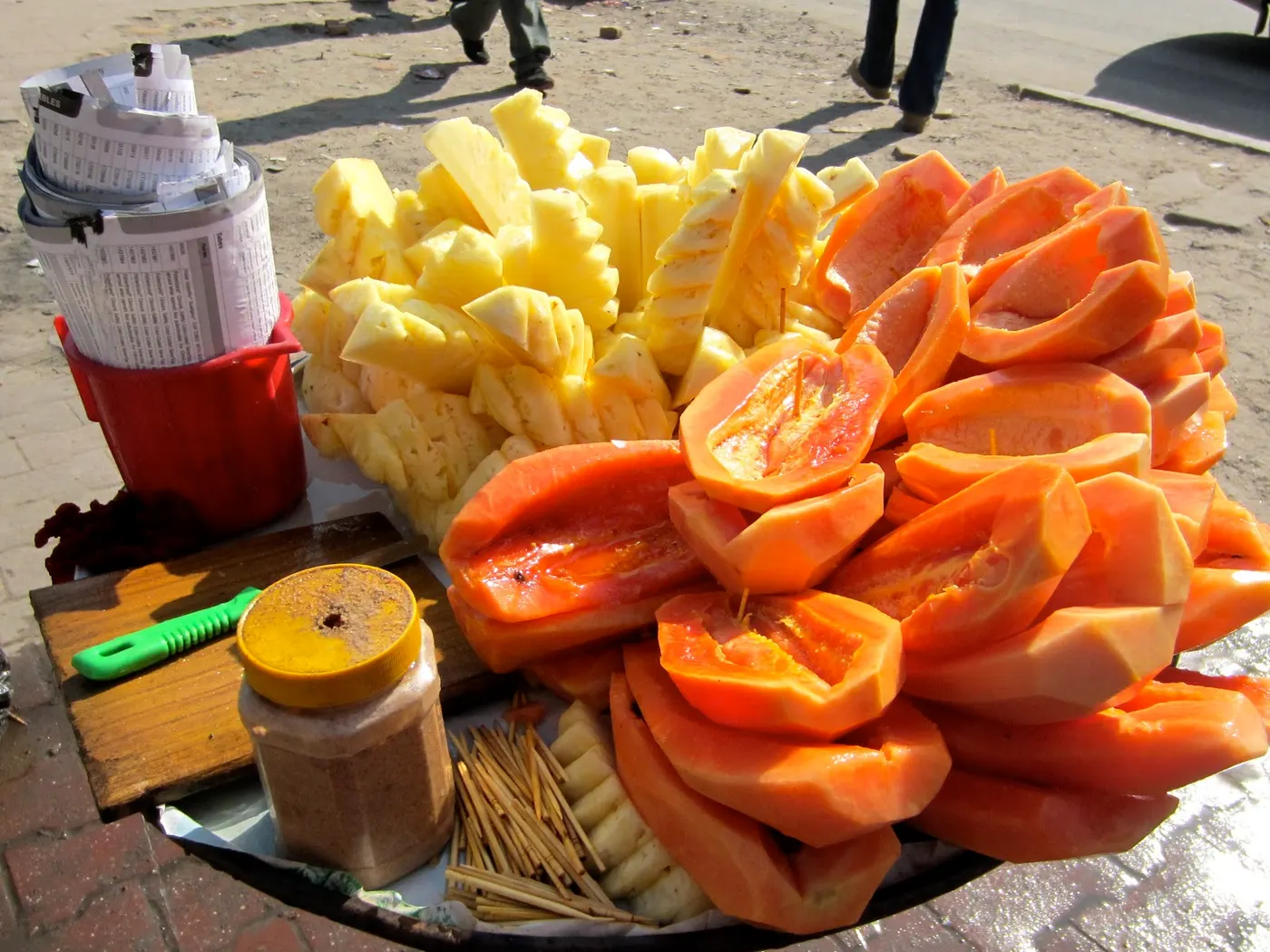 Selling freshly peeled papaya and pineapple in front of Ratna Park area of Kathmandu.
