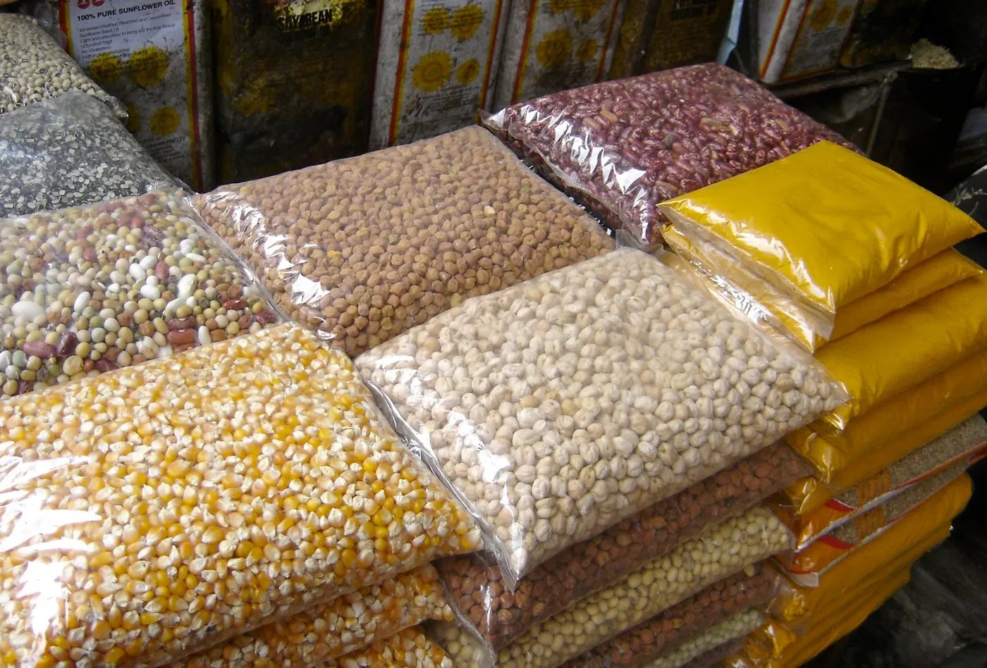 Photo taken at the wholesale market near stone-paved galli (alley) in the Makhan Tole area of Kathmandu, pre-packaged daals (lentils, peas and beans) in clear plastic bags.
