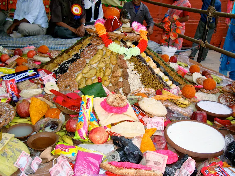 Offerings by devotees include money, newari sweets, and several red clay containers of Juju Dhau - (king of yogurt) delicious creamy yogurt from Bhaktapur is placed around Samay Baji.