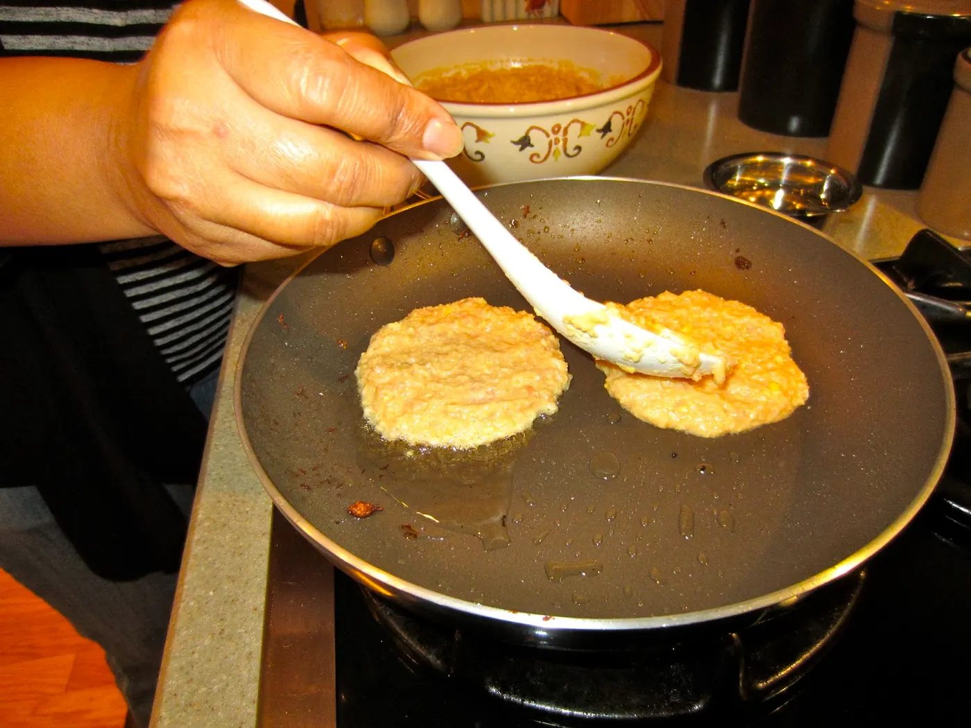 Cook until the edges start to crisp and the underside starts to brown. Turn the Woh over and drizzle 1 teaspoon of oil around the edges and top. Cook until browned both sides.