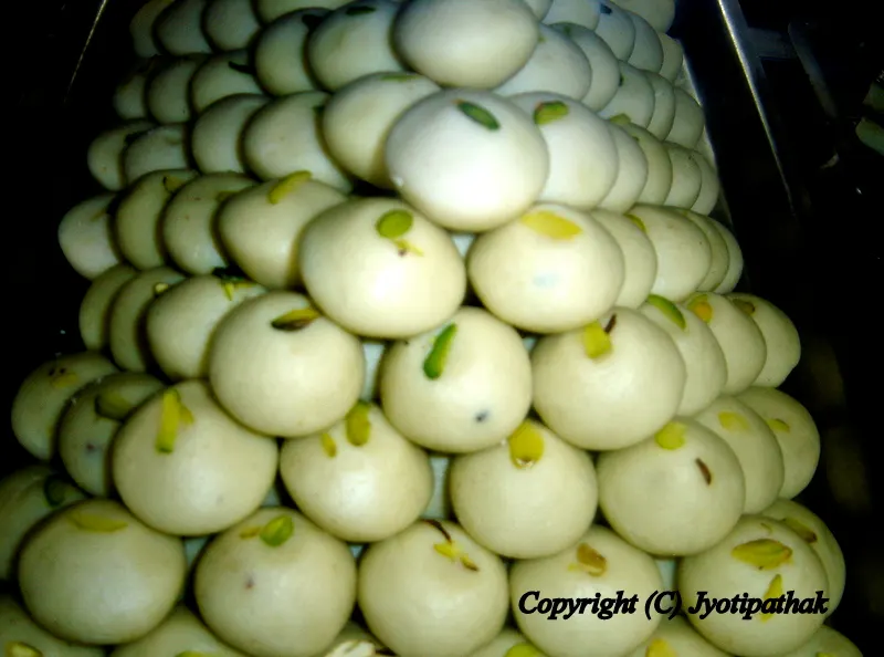 Divinely delicious creamy white Paneer Peda - पनीर पेडा - freshly made from soft Paneer cheese dough, sugar, green cardamom, and decorated with sliced pistachios.