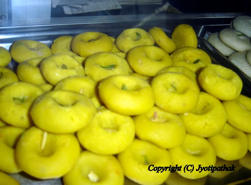 Yellow Keshari Peda - (केशरी पेडा) - (Saffron flavored milk fudge)Peda, a small, round patties prepared from thickened milk, is a popular Nepali sweet. Traditionally, they are made from Khuwaa, which is a slowly simmered-thickened milk.