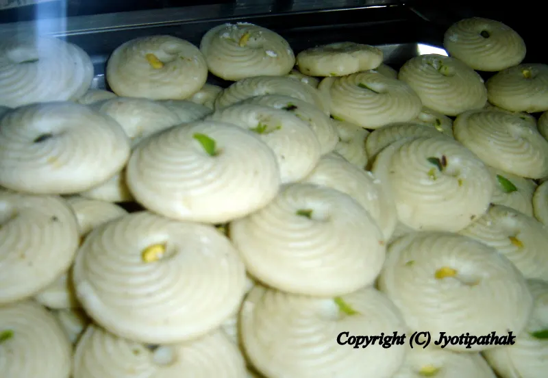Sweet Malai Peda मलाई पेडा- these smooth and silky textured peda are made from thickened milk, sugar and pistachios nut and they are pressed into Round ring mold to create decorative shapes.
