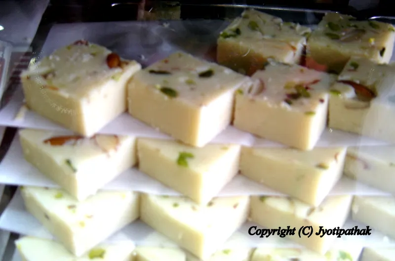 Almond-Coconut Burfi (बदाम-नरिबल बर्फी) - A delicious burfi made from blanched almond and ground coconut and topped with sliced almond and pistachios. You can taste bits of ground almond in every bite.