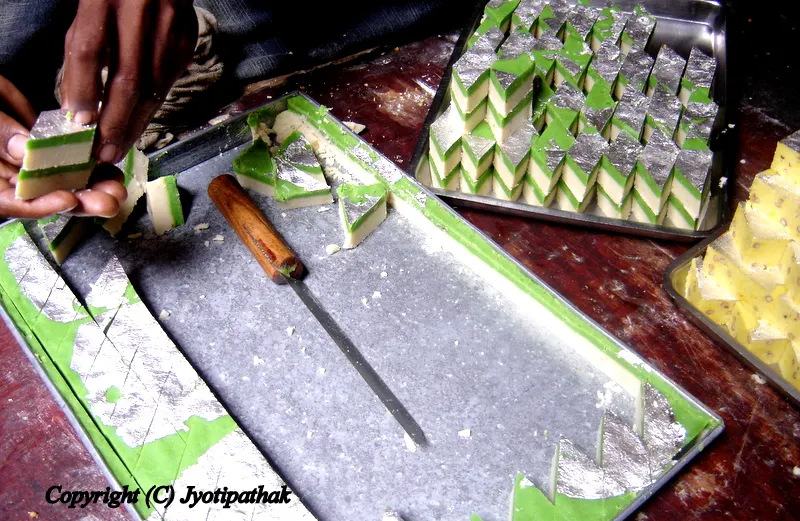 The sweet maker is working on a eye-catching presentation of sweets at a local Haluwai Pasal in Kathmandu.