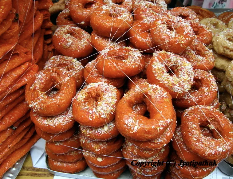 Guleo Roti, (Fried Pastry Rings) - गुलीयो रोटि - glazed and sprinkled with shredded coconut
