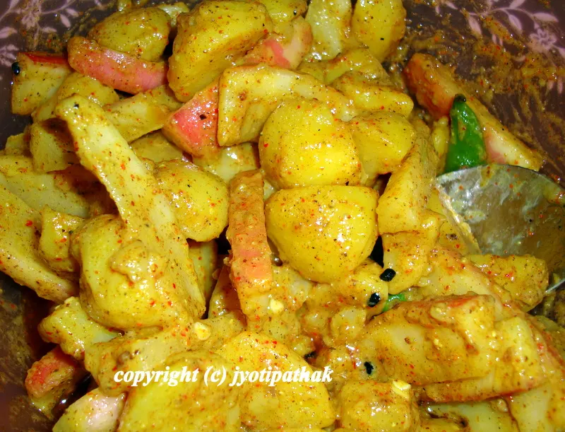 A colorful aloo ko achaar - red from the radish, green from the scallion and fresh coriander, and the white from the onions adds a refreshing touch to this dish.