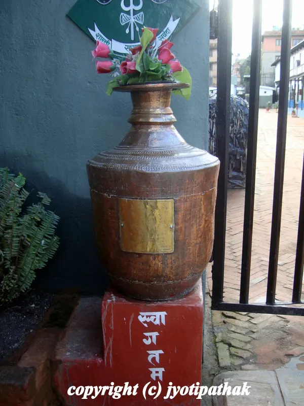 ...Antique copper Kalash with welcoming sign, "Swaagatam" in front of army barracks near the old palaces of Basantpur, Hanuman Dhoka area in Kathmandu