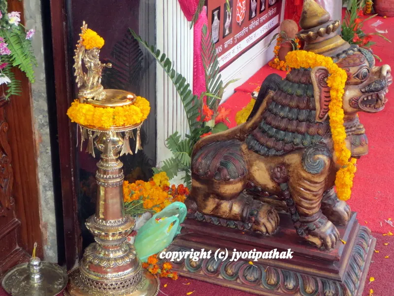 ... the Paanas (brass lamp) at the doorway during Dashain festival - decorated with marigold garlands...