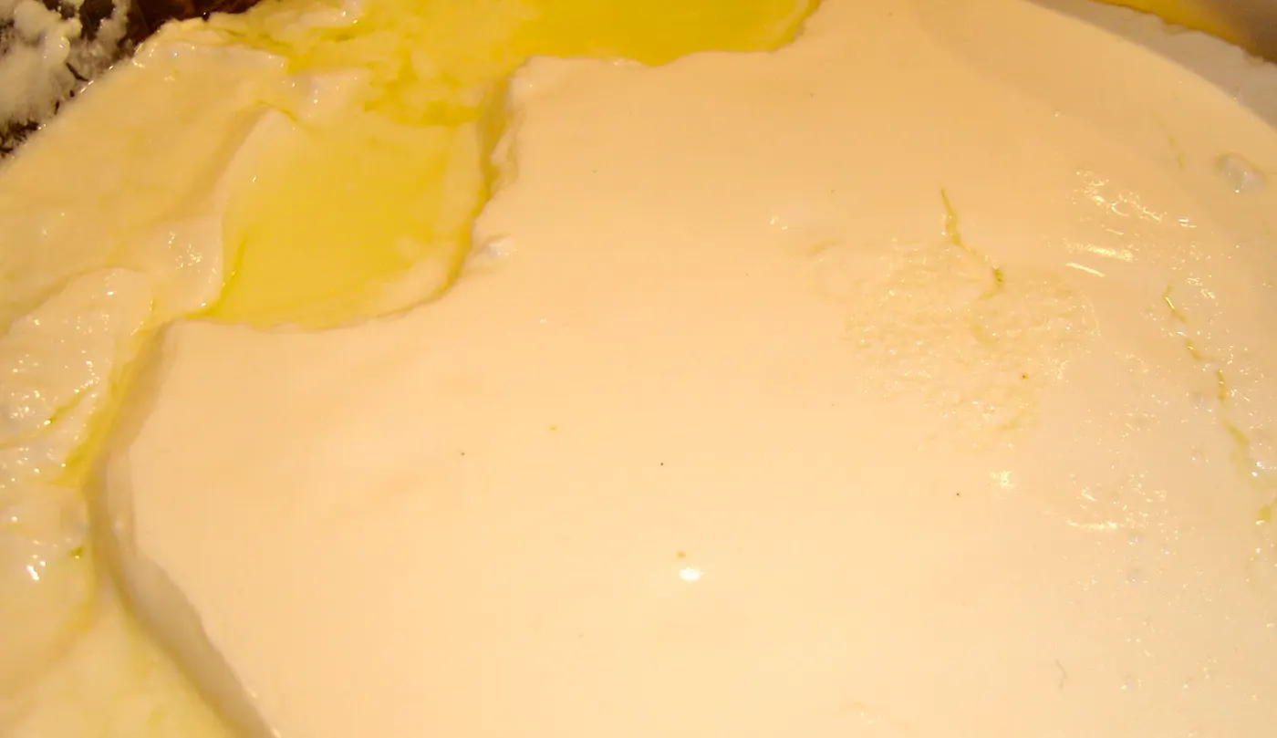... scooping out the yogurt and pouring in a cloth-lined colander...
