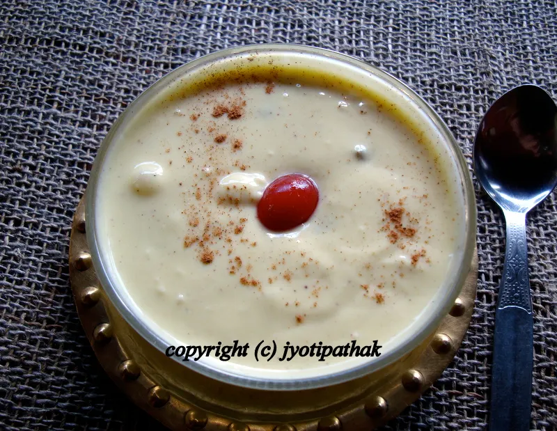 Another picture of sikarni with chopped fruits and nuts in an individual bowl.