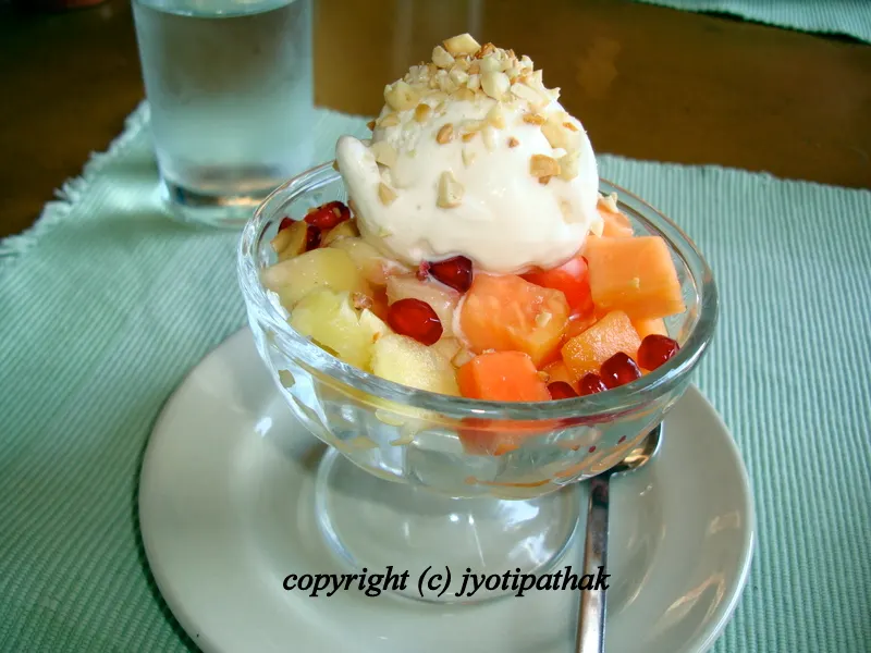 No matter what your favorite fruits are - mangoes, banana, pomegranates, strawberries, lichees, berries - just add the chopped fruits in a decorative bowl, scoop sikarni yogurt dessert as a delicious topping with chopped nuts as a garnish.