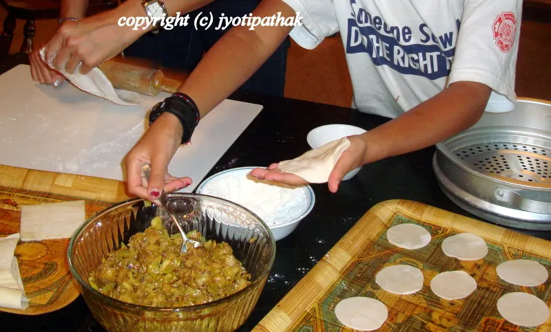 Rolling the dough and filling the momos...
