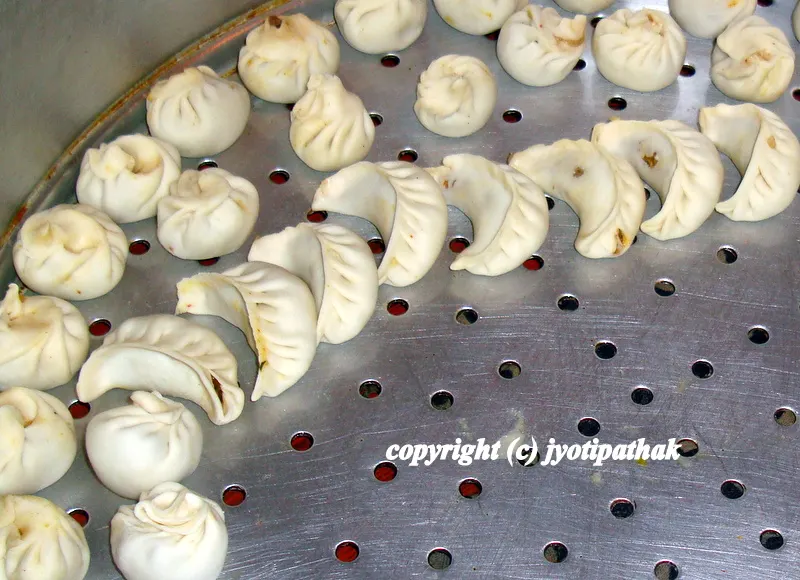 Getting ready to be steamed - arrange the momos on one or two trays, with pleated side up, close together, but not touching.
