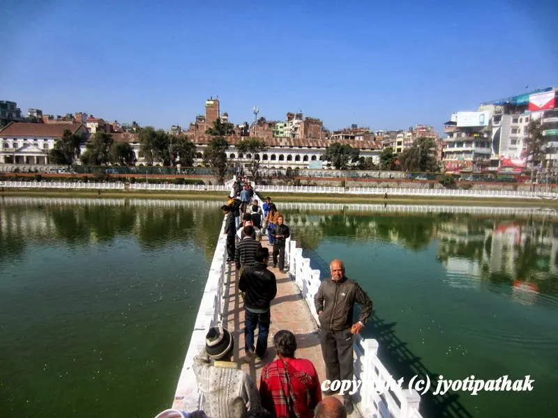Small temple of Rani Pokhari - devotees are visiting the temple located in the center of the pond of Rani Pokhari, Kathmandu. The temple is open once a year during Tihar-Bhai-Tikaa Festival.