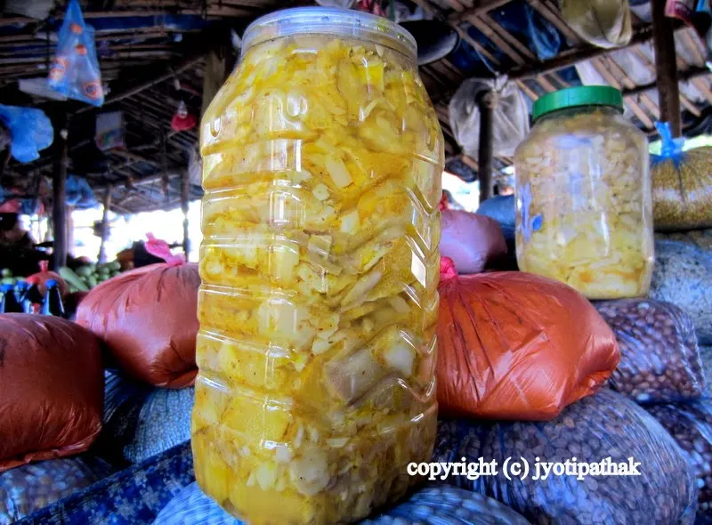Fermented bamboo shoots in a bottle - richly flavored with pickling spices such as ground mustard seeds, salt, ground turmeric, chili powder and mustard oil.