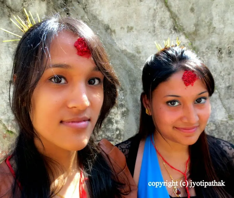 Tikaa and Jamaraa on their forehead, the two young cousins dressed in new clothes are on their way to get tikaa from relatives. They are so happy to pose for me, even wanted to see how their photos came out in my digital camera