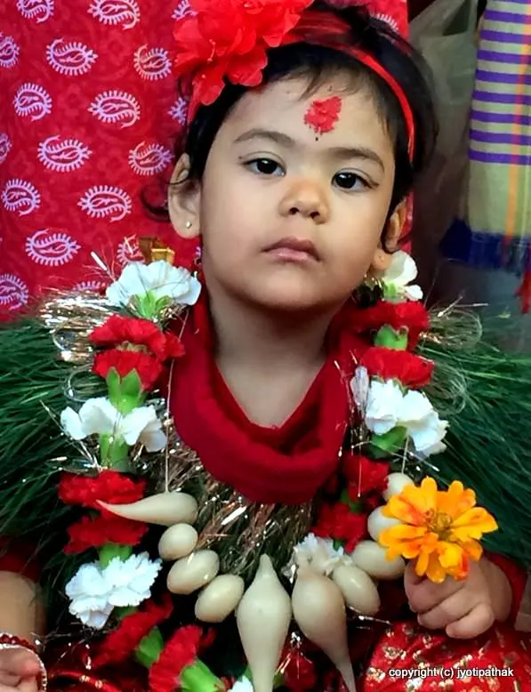 Celebrating Ishani's 2nd birthday wearing garland of yomari bread. In keeping with the culture, yomari is one of the main item on the child's second-year birthday celebration.