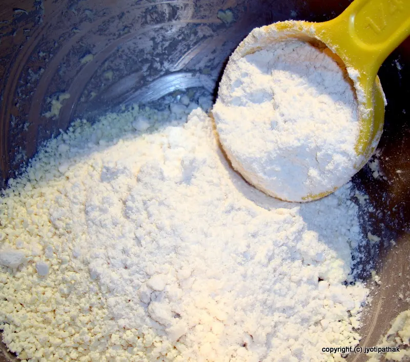 Let's begin making Gulaab Jaamun - combining the powdered milk, flour, and baking soda and mixing well