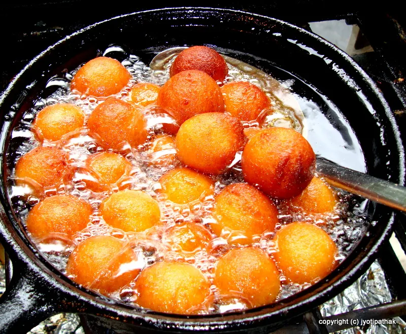 Fry them gently, turning, until they are reddish-brown on all sides. The most important point to remember is not to fry them over high heat, or else the outside will burn very fast, the inside will remain uncooked and doughy.