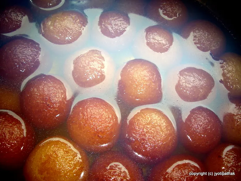 Gently submerge the balls in the warm syrup, and let them soak for at least 2 hours, until they are soft and spongy.
